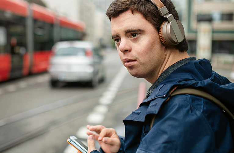 man wearing headphones in a city