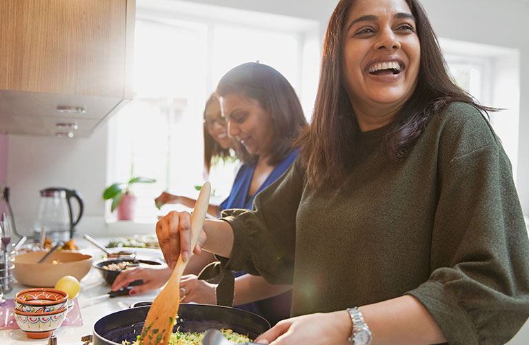 women cooking and smiling